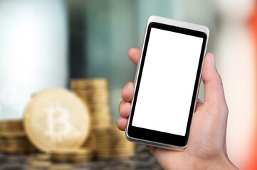 Hand holds smartphone with bitcoin cryptographic on background concept