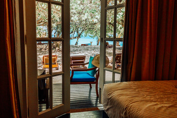 view from room luxury hotel in Maldives to veranda, beach with palm trees and ocean, summer...