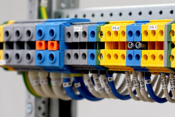Multilevel electrical terminals for connecting mounting wires in an electrical panel close-up.