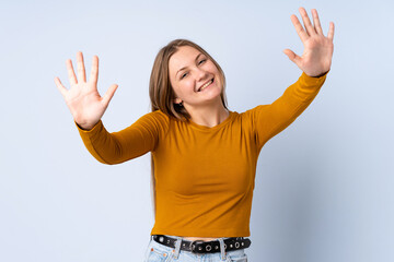 Teenager Ukrainian girl isolated on blue background counting ten with fingers