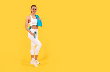 Fototapeta na wymiar sport woman with water bottle on yellow background. copy space