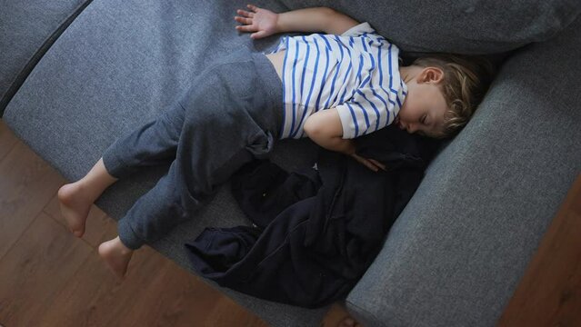 Child napping on couch in the afternoon