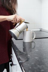 Side view of an unidentified girl serving coffee