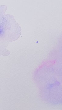 Background with abstract ink stains made with watercolor in blue, purple and pink colors on textured paper