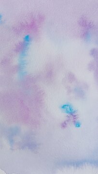 Background with abstract ink stains made with watercolor in blue, purple and pink colors on textured paper