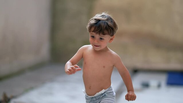 Child running outside shirtless cute kid runs in the sunlight
