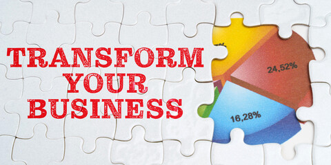 On white puzzles there is an inscription - Transform Your Business. Financial diagram in the window among the puzzles