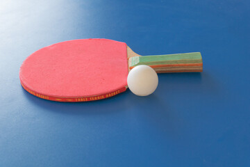 loseup of a red ping pong table and a white table on a blue table