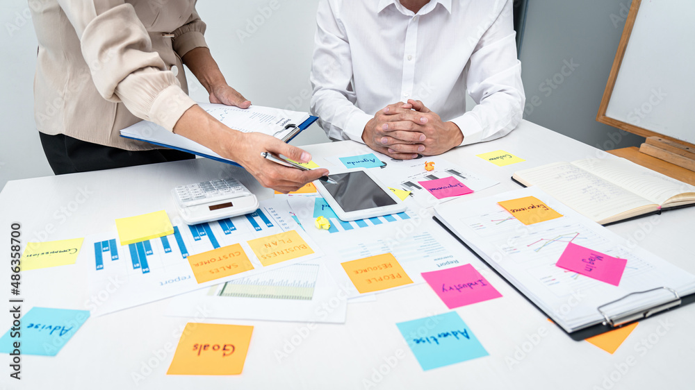 Poster Businesswoman holding document and pointing data on tablet to explaining business report to executive