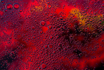 Bubbles in oil in water on pink, black and yellow colour abstract background