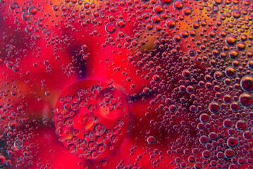 Bubbles in oil in water on pink, black and yellow colour abstract background