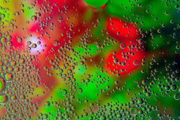Bubbles in oil in water on green and red colour abstract background