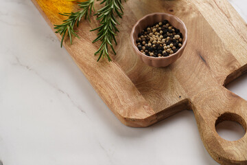 Cooking ingredients: olive oil, fresh rosemary, milk, pepper on wooden board