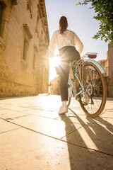 woman takes a bike ride in an city break sunny day