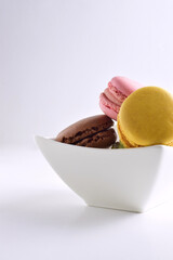 Macaroons of assorted flavors, isolated on white background, typical French sweet.
Copy space and vertical shot.