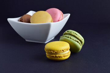 Macarons, isolated on black background, typical french sweet.