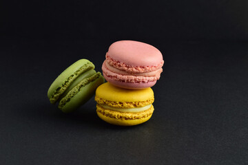 Close up, macarons, isolated on black background, typical french sweet.