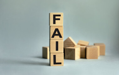 The inscription FAIL on wooden cubes isolated on a light background. The image symbolizes the beginning of the new year.