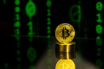 Pile of bitcoins with binary code blockchain background. Crypto currency future of financial trading concept