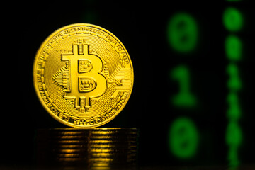 Close up shot of bitcoin with binary code blockchain background. Future digital crypto currency payment system concept