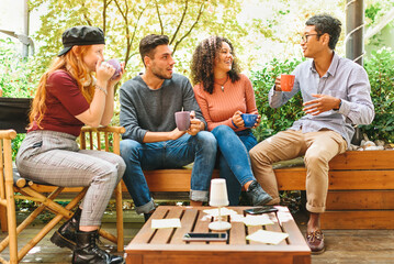 Group of multicultural young friends hanging out on a patio