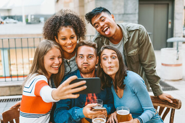 Diverse friends having fun while taking selfie