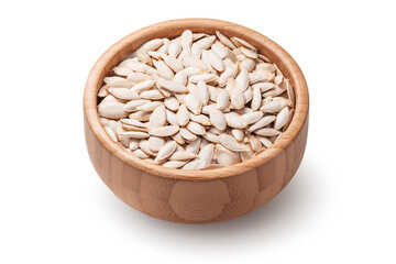 Pumpkin seeds in wooden bowl isolated on white background.