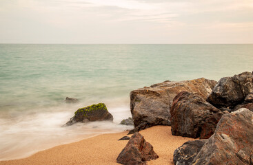 Fototapeta na wymiar Rocks on the beach at sunset