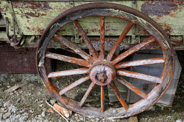 A wooden spoked wheel on an old wagon