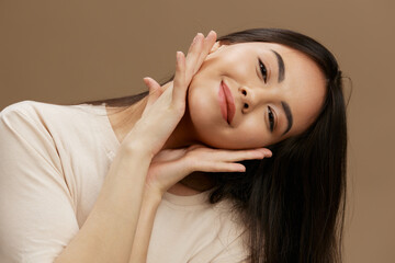 Fototapeta premium Brunette in a beige T-shirt posing clothing fashion Lifestyle