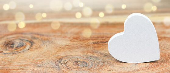 White heart on abstract wooden background. Love concept.