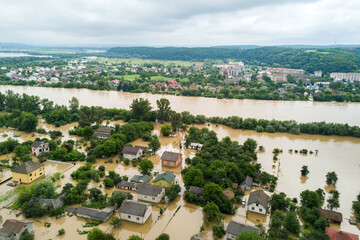 Fototapeta na wymiar Aerial view of flooded houses with dirty water of Dnister river in Halych town, western Ukraine