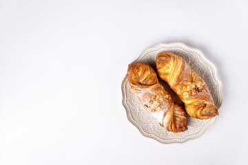 Buns with marzipan on white ceramic plate, copy space