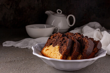 cake slices from light and dark dough in a white ceramic plate