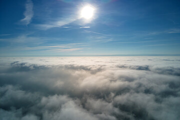 Aerial view from high altitude of earth covered with puffy rainy clouds forming before rainstorm