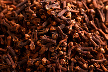 Aromatic spice cloves herbs on rustic table