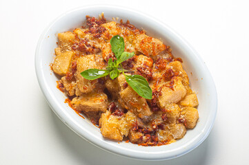 .Fried cassava with tomato sauce, grated parmesan and basil