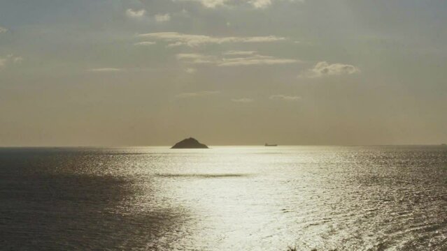View of sunset sea and small island in winter day.