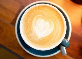 cup of coffee or hot chocolate on the wooden background in cafe
