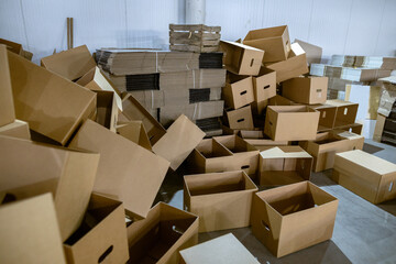 Assembled and disassembled folding cardboard boxes of perforated sheets of corrugated cardboard....