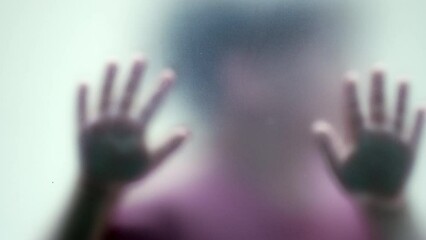 Kid stuck behind matte defocused glass child abuse concept