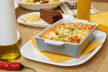 Hot dishes with pasta, cheese, vegetables and meat