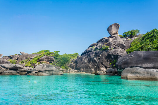 Beautiful landscape people on rock is a symbol of Similan Islands, blue sky and cloud over the sea during summer at Mu Ko Similan National Park, Phang Nga province, Thailand