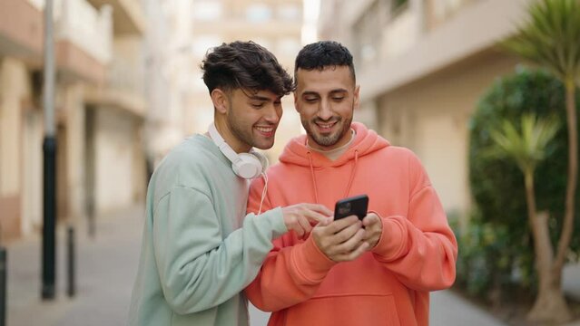 Young hispanic couple smiling confident making selfie by the smartphone at street