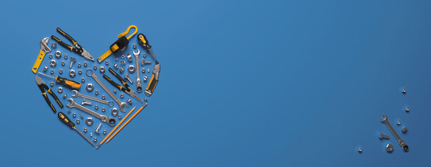 A symbolic heart made of construction tools set. Creative template for the Builder's Day, Labor Day (and similar professional holidays) or the Valentine's Day greeting card or banner. 3D render. © Anna