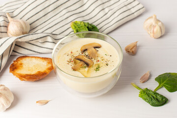 garlic soup puree on a white table