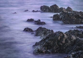 Water with rock nature photo with long exposure fog effect abstract color ocean background 
