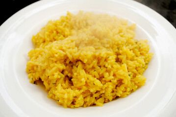 Side Dish of Steaming Herb and Yellow Rice	