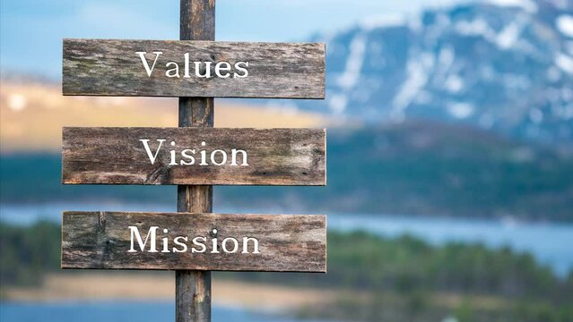 Values vision mission wooden signpost outdoor in nature during blue hour and sunset. Business concept.