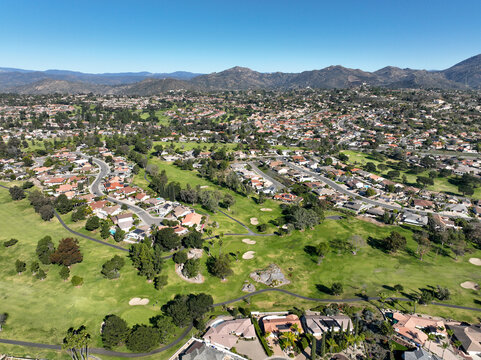 Aerial view of green golf in upscale residential neighborhood in South California. USA. 
